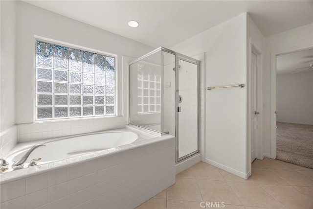 bathroom featuring a garden tub, a stall shower, and tile patterned flooring