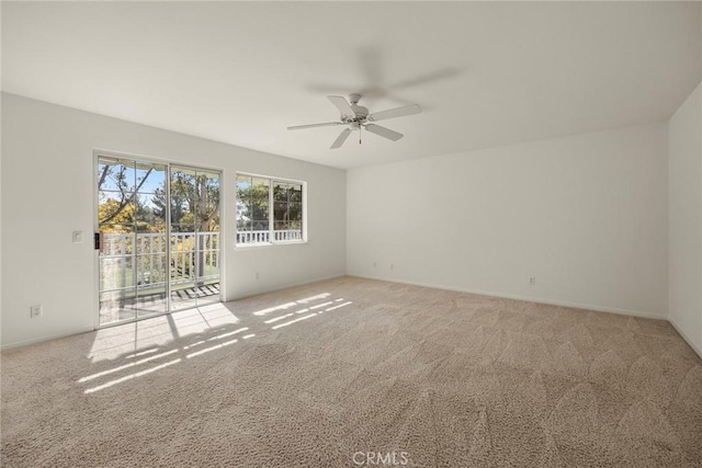 spare room featuring ceiling fan and carpet flooring