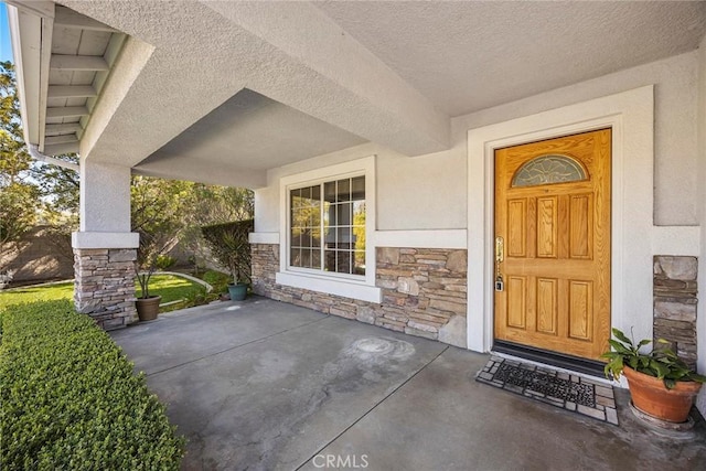 property entrance with stone siding and stucco siding