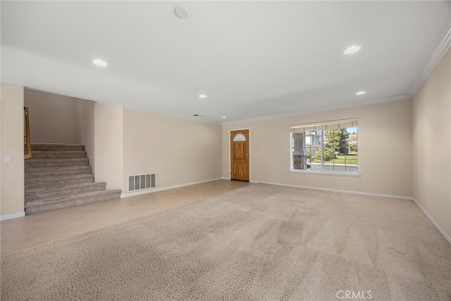 interior space featuring light tile patterned floors, baseboards, light colored carpet, stairway, and crown molding