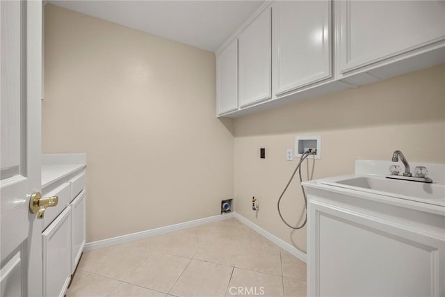 washroom featuring cabinet space, light tile patterned floors, a sink, washer hookup, and electric dryer hookup