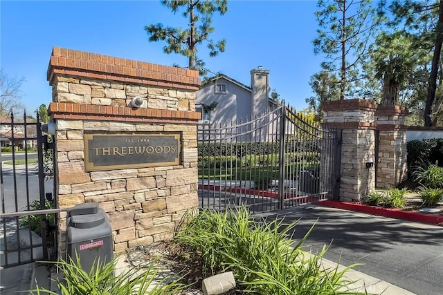 community / neighborhood sign with a gate