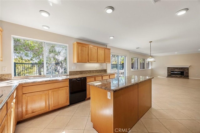 kitchen with black dishwasher, stone counters, light tile patterned flooring, and a kitchen island