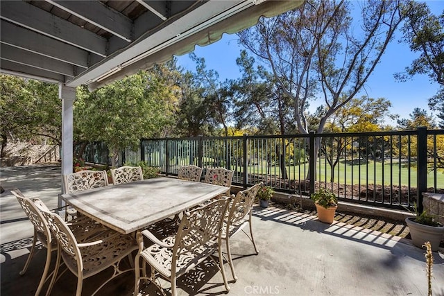 view of patio / terrace featuring fence and outdoor dining area