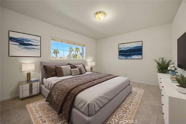 bedroom with baseboards and light colored carpet