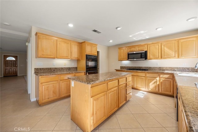 kitchen featuring stone counters, recessed lighting, black appliances, and light tile patterned floors