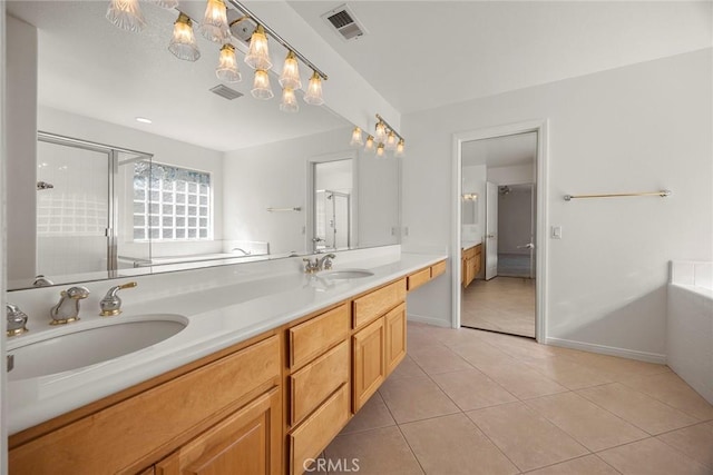 full bathroom featuring tile patterned flooring, visible vents, a sink, and a shower stall