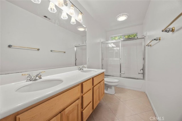 full bathroom featuring double vanity, tile patterned flooring, visible vents, and a sink