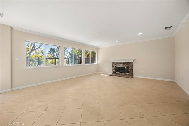 unfurnished living room with a stone fireplace, ornamental molding, visible vents, and baseboards