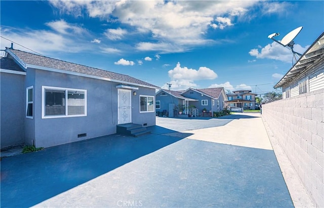 view of street with entry steps and a residential view