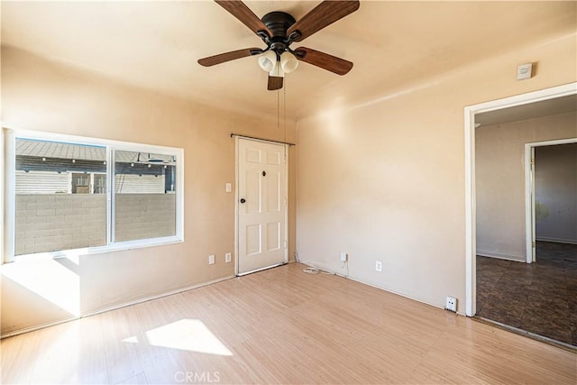 spare room featuring a ceiling fan and wood finished floors