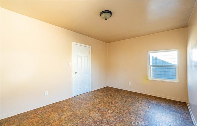 empty room with baseboards