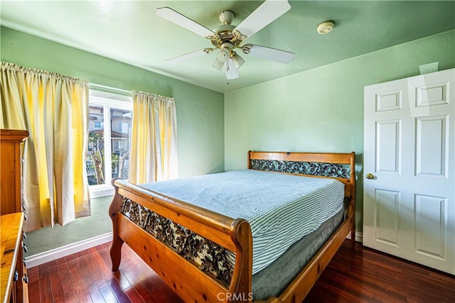 bedroom with ceiling fan, wood-type flooring, and baseboards