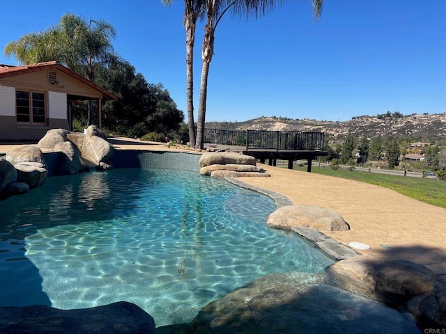 view of pool with a fenced in pool and a mountain view