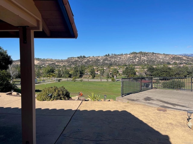 view of yard featuring a mountain view and a patio