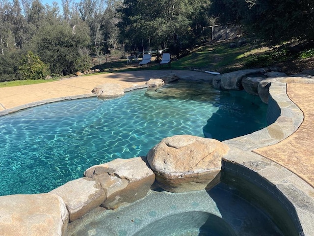 outdoor pool featuring a patio area