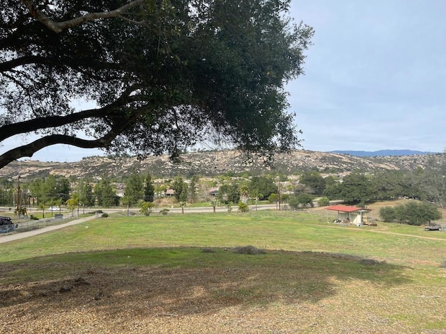 view of yard featuring a rural view and a mountain view