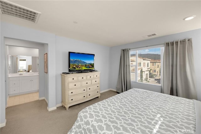 bedroom with carpet floors, baseboards, and visible vents