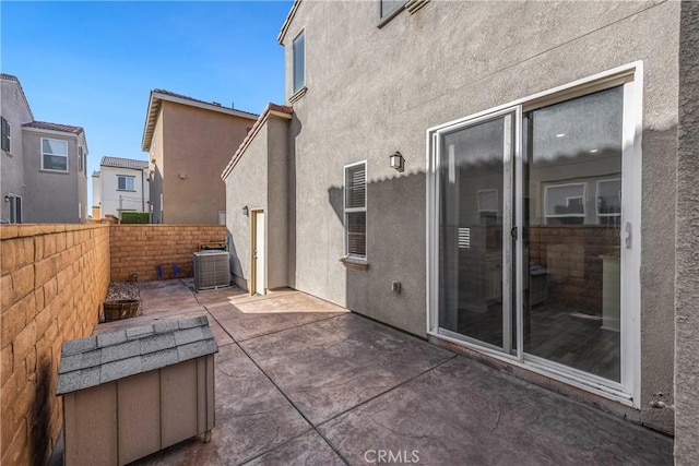 view of patio / terrace featuring central AC and fence