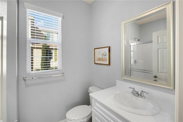 full bathroom with toilet, an enclosed shower, and vanity