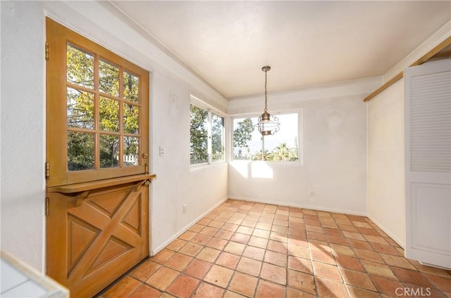 unfurnished dining area featuring baseboards