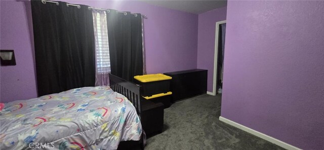 bedroom with carpet floors and baseboards