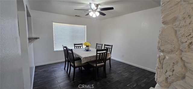 dining space with dark wood-type flooring, visible vents, and baseboards