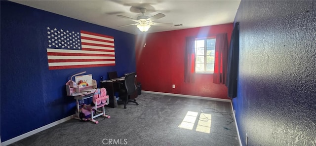 unfurnished office featuring a ceiling fan, carpet, visible vents, and baseboards