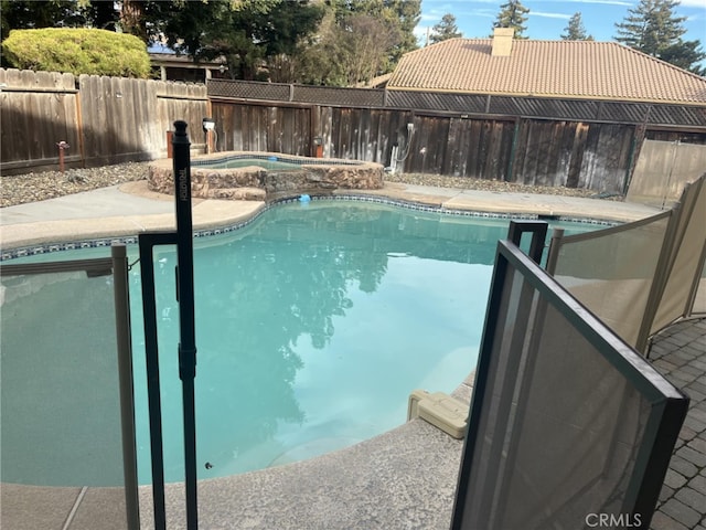 view of swimming pool with a fenced backyard and a fenced in pool