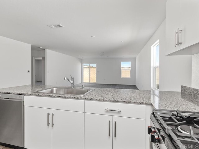 5106 Belle Way, Hemet, CA 92545 - kitchen with visible vents, range with gas stovetop, stainless steel dishwasher, white cabinetry, and a sink