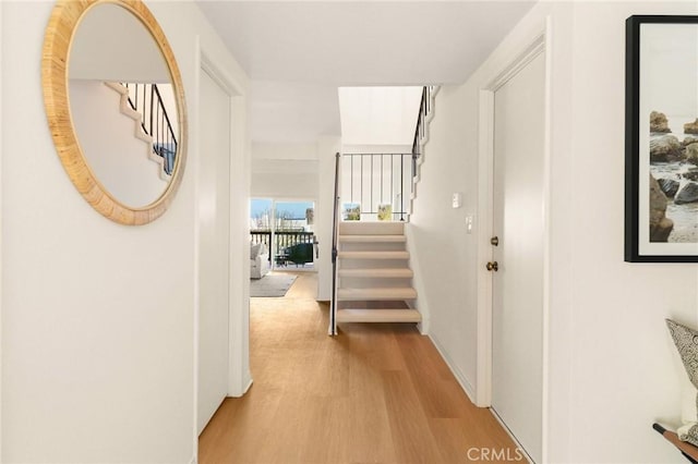 corridor with stairway and wood finished floors