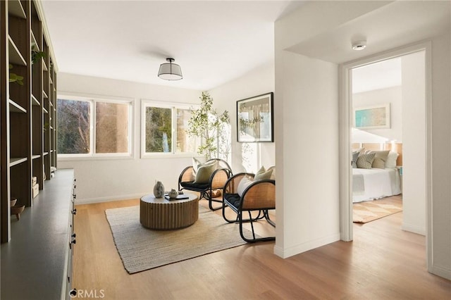 sitting room with baseboards and wood finished floors