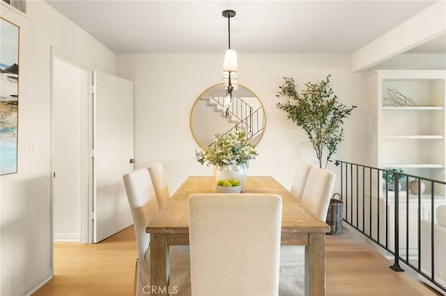 dining space featuring visible vents and light wood-style flooring