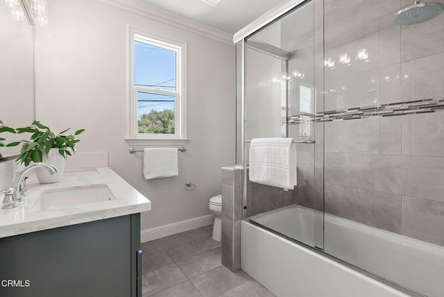 full bath with double vanity, toilet, ornamental molding, a sink, and tile patterned flooring