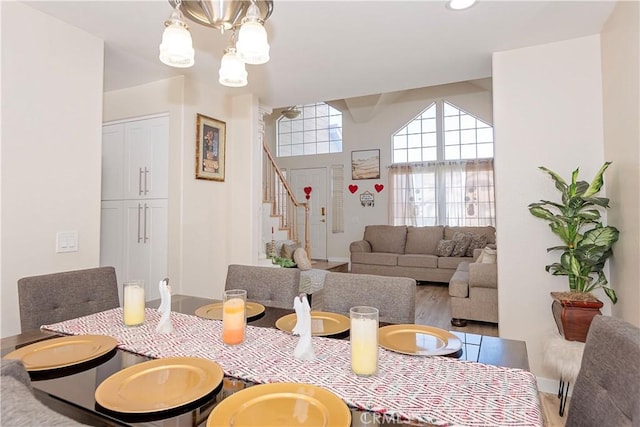 dining space with a chandelier and stairway