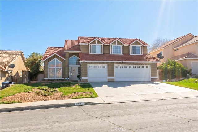 traditional-style home featuring a garage, driveway, and a tile roof