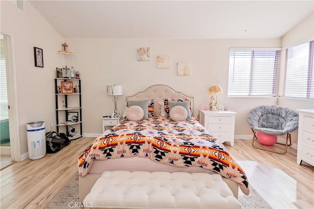 bedroom with wood finished floors and baseboards