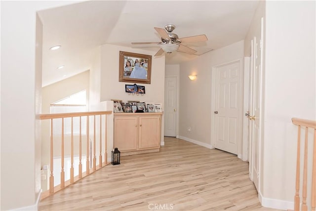 corridor featuring recessed lighting, light wood-style flooring, and baseboards