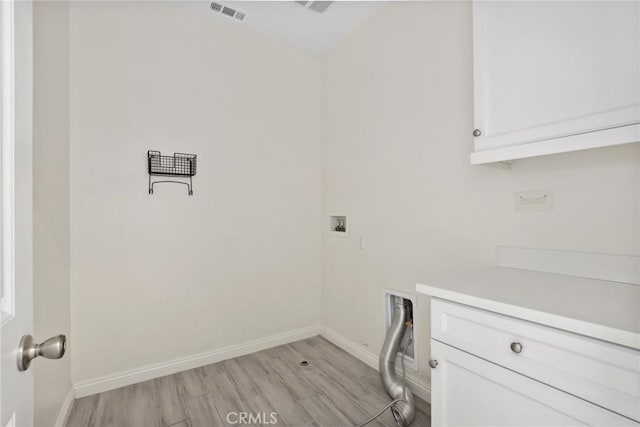 3235 E Yellowstone Dr, Ontario, CA 91762 - laundry area with light wood-style flooring, baseboards, visible vents, cabinet space, and hookup for a washing machine