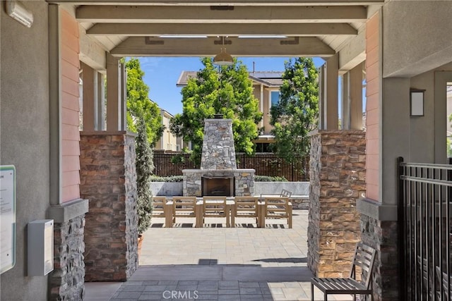 3235 E Yellowstone Dr, Ontario, CA 91762 - view of patio / terrace featuring an outdoor stone fireplace and fence