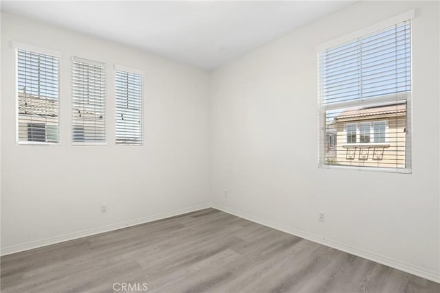 3235 E Yellowstone Dr, Ontario, CA 91762 - unfurnished room featuring baseboards, a healthy amount of sunlight, and wood finished floors