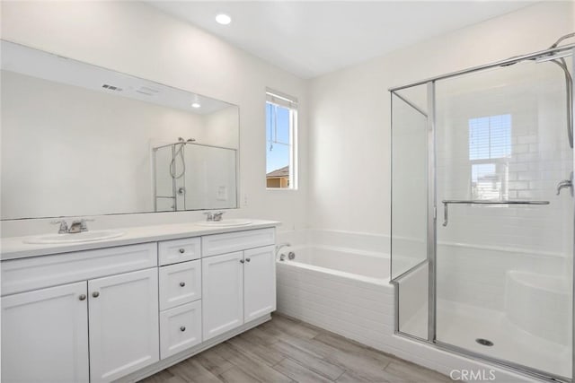 3235 E Yellowstone Dr, Ontario, CA 91762 - bathroom with a shower stall, double vanity, a bath, and a sink