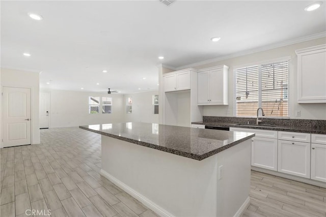 3235 E Yellowstone Dr, Ontario, CA 91762 - kitchen featuring white cabinetry, crown molding, a sink, and a kitchen island