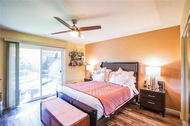 bedroom featuring access to outside, wood finished floors, a ceiling fan, and baseboards