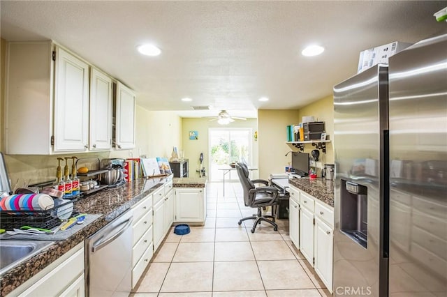 kitchen with recessed lighting, appliances with stainless steel finishes, white cabinets, and light tile patterned flooring