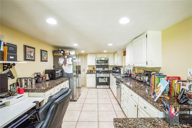 kitchen with stainless steel appliances, light tile patterned flooring, white cabinets, and recessed lighting