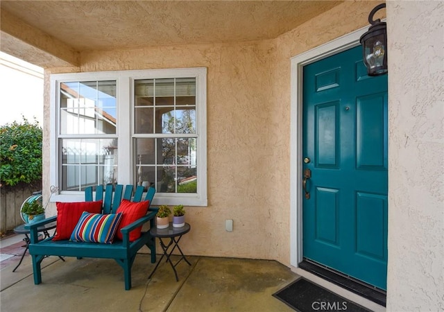 entrance to property featuring stucco siding