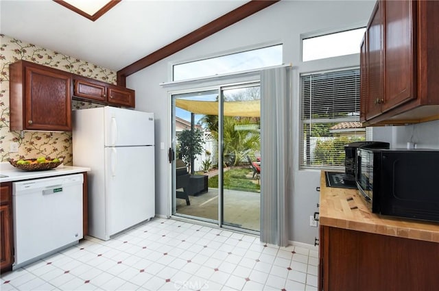 kitchen featuring white appliances, wallpapered walls, lofted ceiling with beams, butcher block counters, and light floors