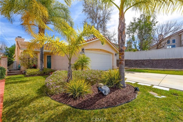 view of front of home with a garage, stucco siding, a chimney, fence, and a front yard