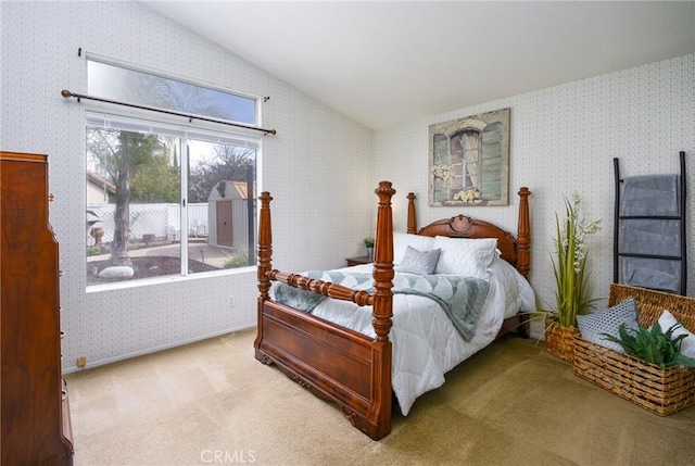 bedroom featuring vaulted ceiling, carpet flooring, and wallpapered walls